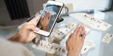 Hand of young woman trying on ring with blue gemstone